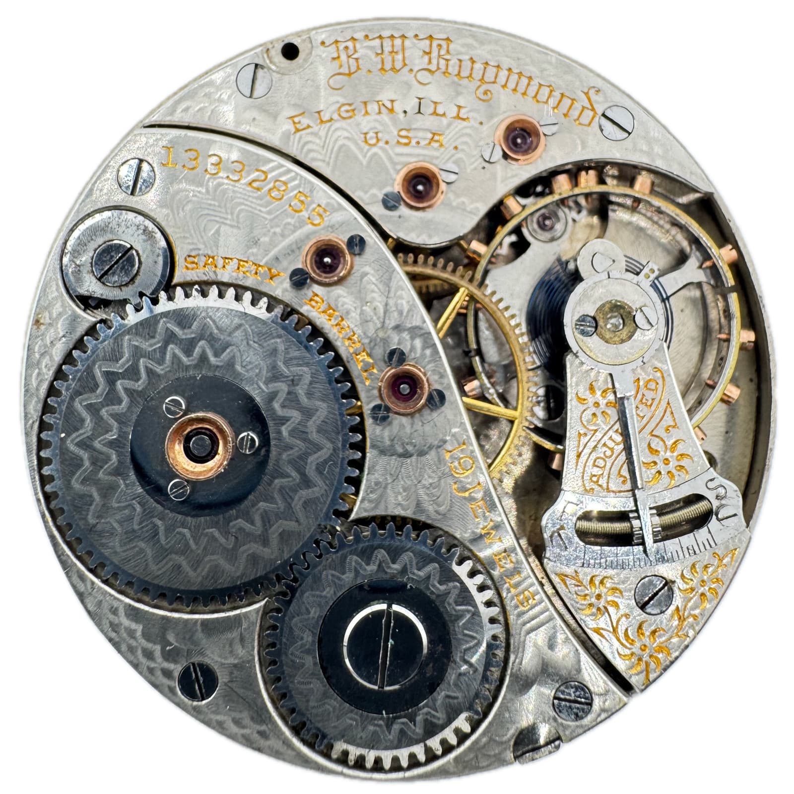 白い背景の、ケースから外した銀色の機械。金色の文字で「B.W. Raymond」「ELGIN, ILL. U.S.A.」の刻印と歯車が見える